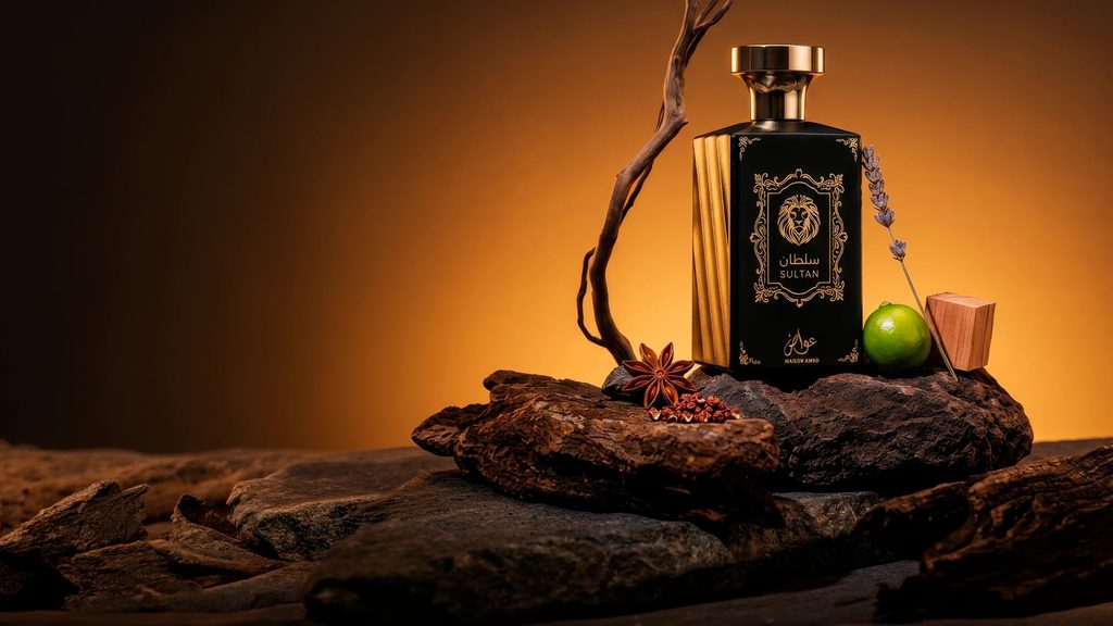 Frasco de perfume da Maison Awad sobre madeira, com anis-estrelado, lavanda e uma lima ao lado, em fundo âmbar